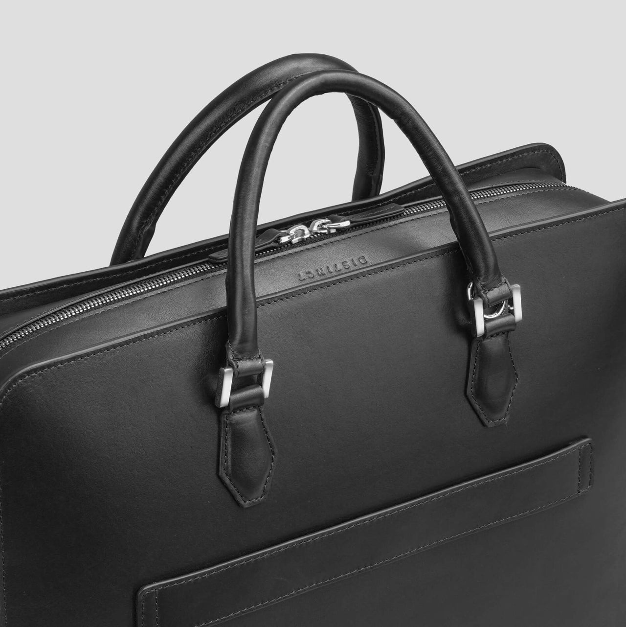 Black leather briefcase with handle and visible brand logo of the brand DISTINCT on a light gray background 